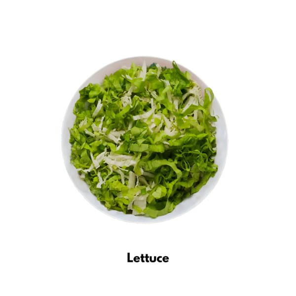 A white bowl filled with fresh, shredded green lettuce, ready as a topping for Tacos El Primo.