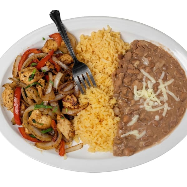 Chicken fajitas with grilled onions and peppers, yellow rice, and refried beans with cheese.